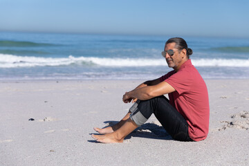 Fototapeta na wymiar Senior Caucasian man enjoying time on the beach