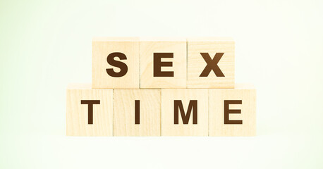 words sex time made with small wooden cubes on light green