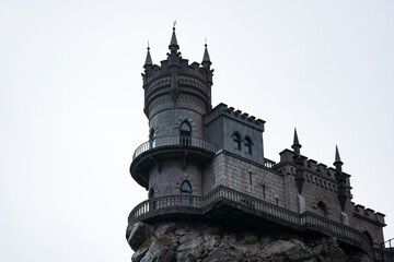 Fototapeta na wymiar Historical architectural monument of the southern coast of Crimea swallow's Nest castle. It is located on a steep cliff that goes into the sea.