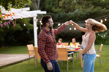 Happy couple dancing in the garden © wavebreak3