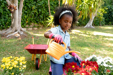 African American girl planting flowers.