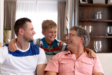 Senior Caucasian man spending time with his son and his grandson at home 