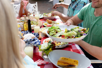 Caucasian family sitting at table during a family lunch in the garden