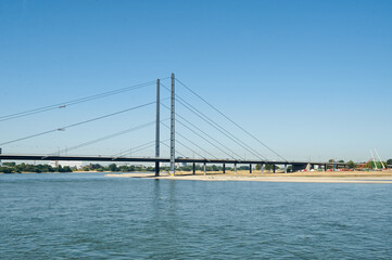 Fototapeta na wymiar Dusseldorf, Germany – July 24, 2019: The Rheinkniebrücke is a cable-stayed bridge over the Rhine in Düsseldorf, opened to traffic on 16 October 1969.