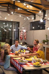 Multi-generation Caucasian family praying before eating