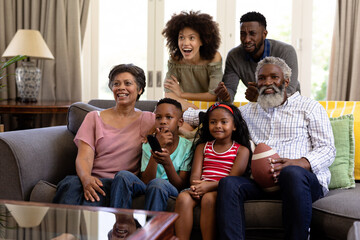Mixed race family spending time together watching game