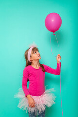 Little girl holding a pink balloon