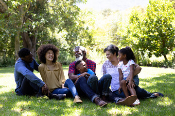 Fototapeta premium Multi-generation mixed race family enjoying their time at a garden