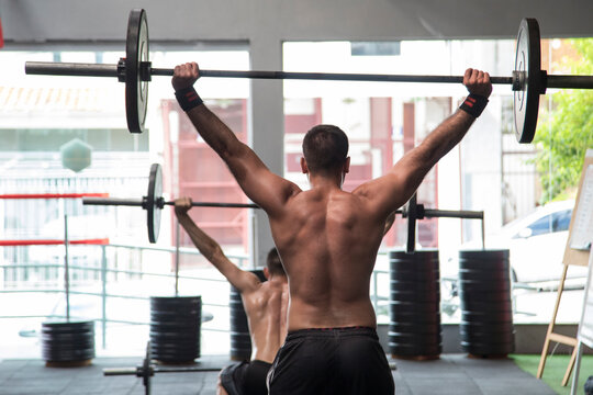 Muscular Man Lifting Weights