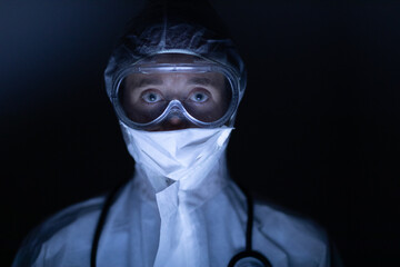 Healthcare worker wearing protective suit and face mask during coronavirus Covid19 pandemic