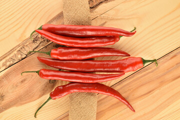 Red chili peppers, close-up, on a wooden table.