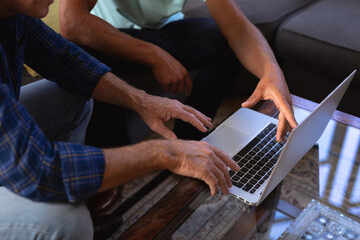 Close up of Senior Caucasian man sitting on a couch and using a laptop