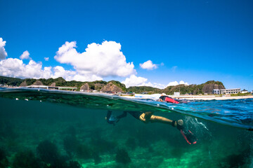 Snorkelling in Japan an underwater world full of seaweed and amazing seascapes. A caucasioan man...