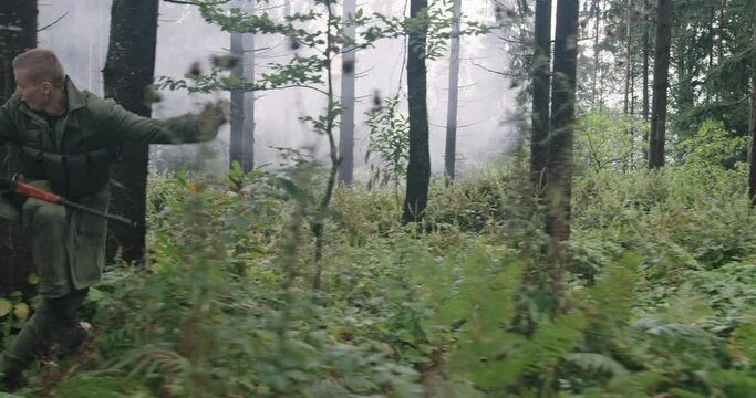 Military action in dense forest, running after terrorist, concept of war and terrorism