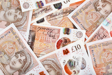 A lot of United Kingdom 10 pounds banknotes. Money horizontal background