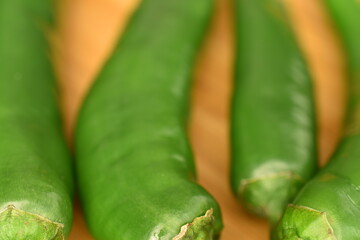 Green chili pepper, close-up, on a black background.