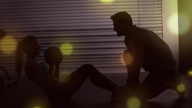Sport trainer helping woman to do exercices