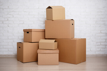 cardboard boxes over white brick wall