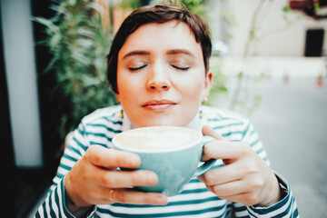 Girl enjoys drinking morning aromatic freshly brewed coffee, healthy breakfast