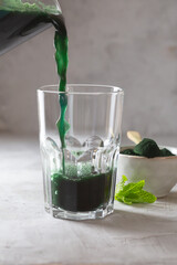Green drink prepared with single celled green algae chlorella. Detox superfood in the glass