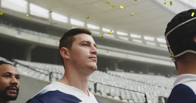 Animation of golden confetti falling over a multi-ethnic team standing in a row on a pitch 