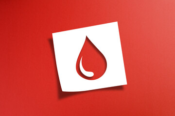 Note paper with blood donation concept on red background - obrazy, fototapety, plakaty