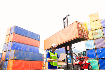 Foreman or Operator Ordering of moving containers via laptop computer. Foreman looking forward on Forklifts in the Industrial Container Cargo freight ship.