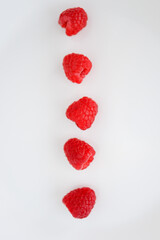 Close-up or macro a line or a row of ruby red raspberry fruit like a string of rubies