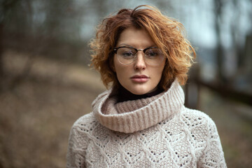 Closeup photo of a cute woman with glasses in nature