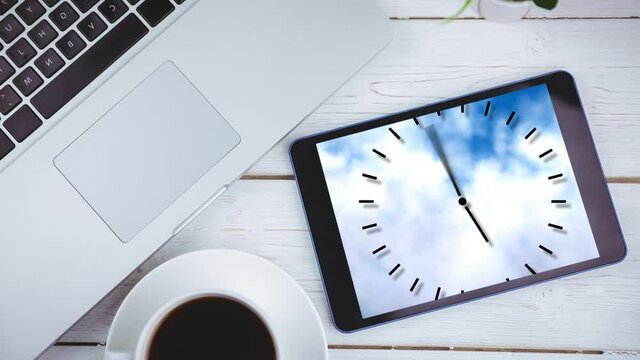Animation of a digital tablet showing clock ticking on the screen