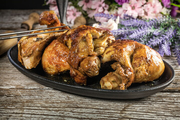Quarters of fried chicken in a cast iron skillet.