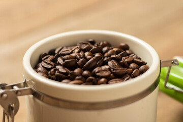 can with grains of coffee on a wooden table. Banner. Concept of coffee, plantation, processing, collection. Top view, flat lay