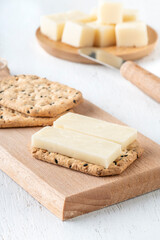 sliced cheese served on a biscuit cracker as a appetizer