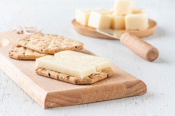sliced cheese served on a biscuit cracker as a appetizer