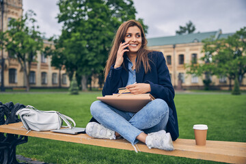 Female with backpack and studying materials outside