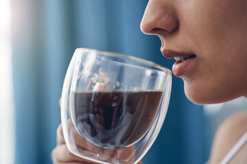 Young woman drinking morning hot beverage at home