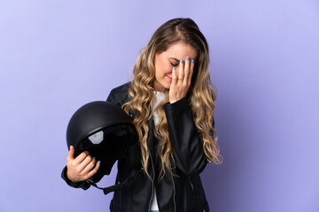 Young Brazilian woman holding a motorcycle helmet isolated on purple background with tired and sick expression