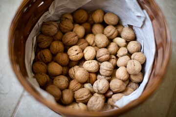 Shelled walnuts in the basket. Natural and organic village walnuts. There is also some shelled almonds in the basket. 