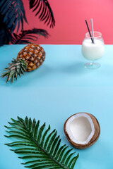 tropical background pink with coconut and pineapple top view. High quality photo