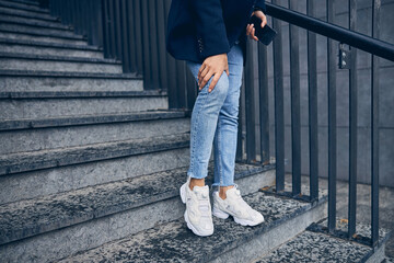 Female in casual clothes alone outside near building
