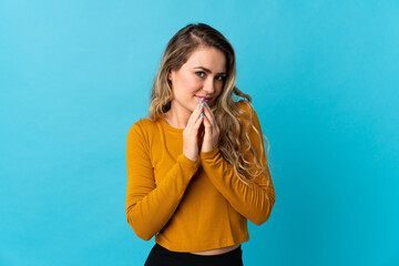 Young Brazilian woman isolated on blue background scheming something