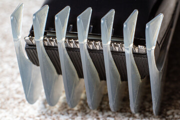 Fototapeta premium A razor with a trimmer for cutting and shaving hair, with a comb nozzle. Care for beard and hair