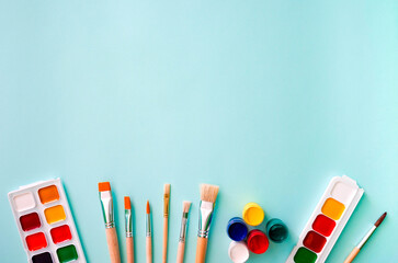Two sets of multicolored watercolor paints, five gouache paints, three light beige brushes with...