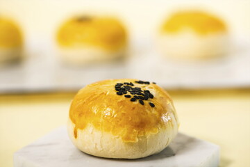 egg-yolk puff, sprinkled with sesame seeds.
