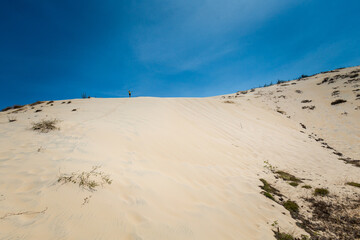 Young man on White sand dunes in Vietnam