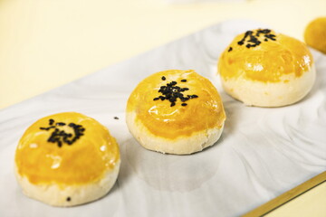 egg-yolk puff, sprinkled with sesame seeds.
