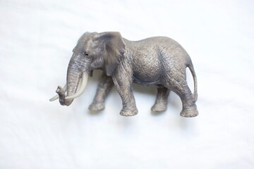 Toy plastic elephant. African elephant view on white background. Animal plastic toys for kids. 