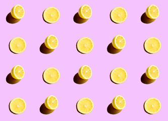 Series of half cut lemons on a purple background