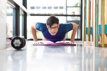 Mature Asian man Doing Exercises at Home. workout at home. social distancing.