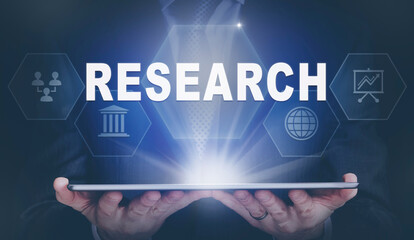 Businessman holding a computer tablet display projecting a Research concept.